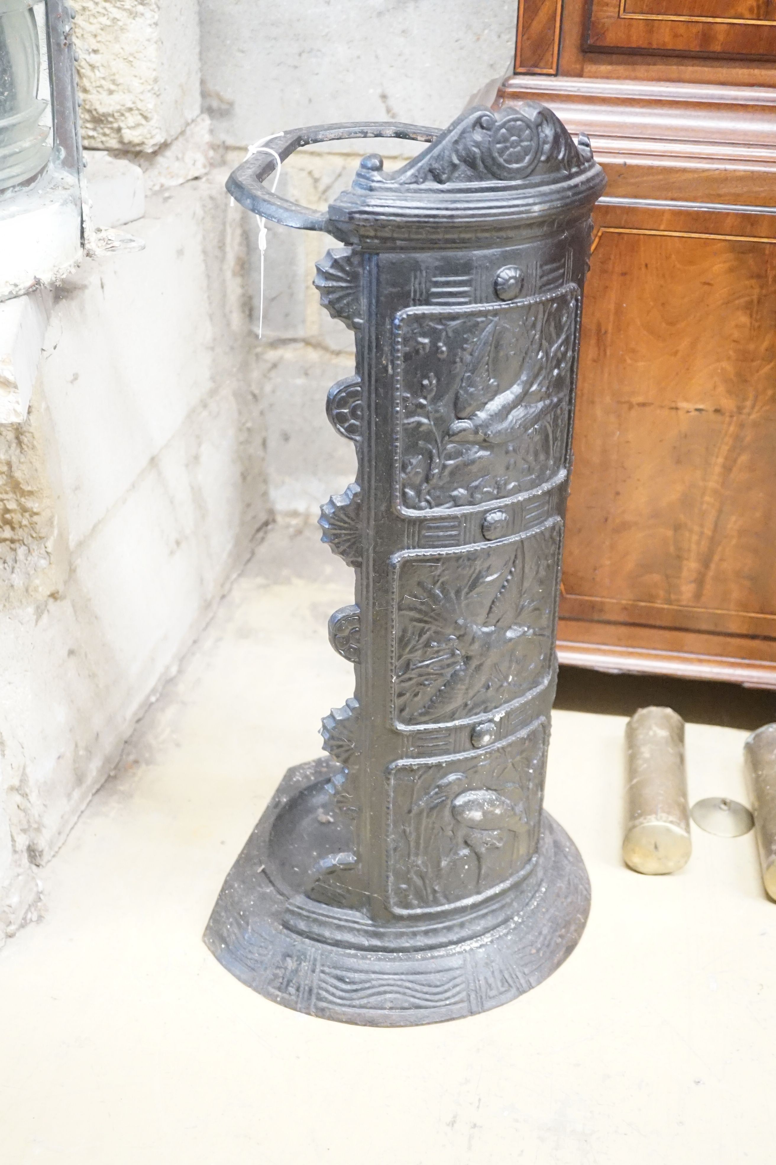 A cast iron panelled umbrella stand, height 66cm